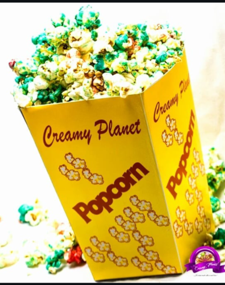 Branded Creamy Planet popcorn box filled with colourful popcorn