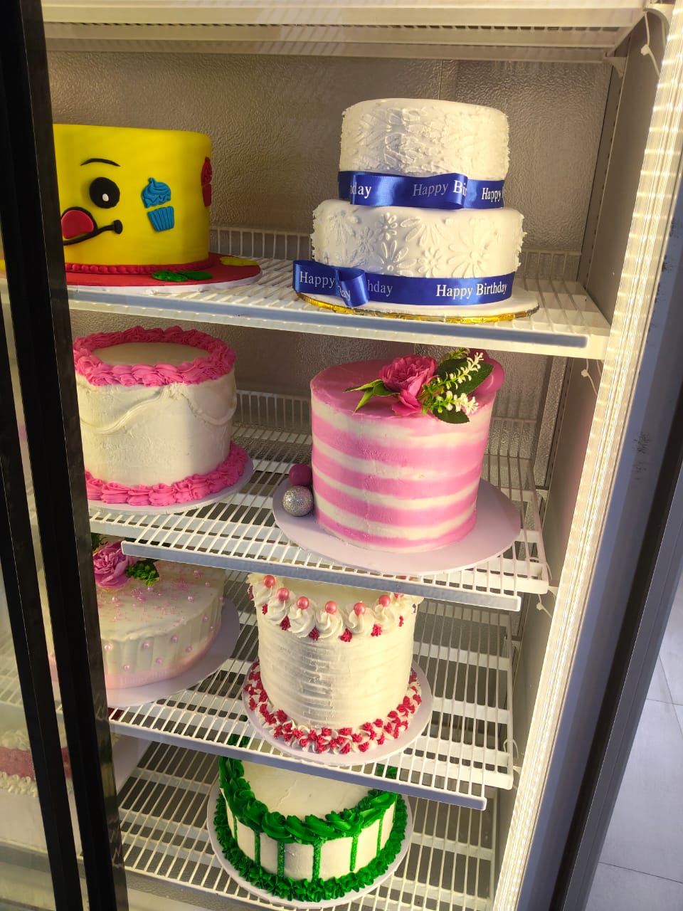 Tiered birthday cakes and character cakes on display