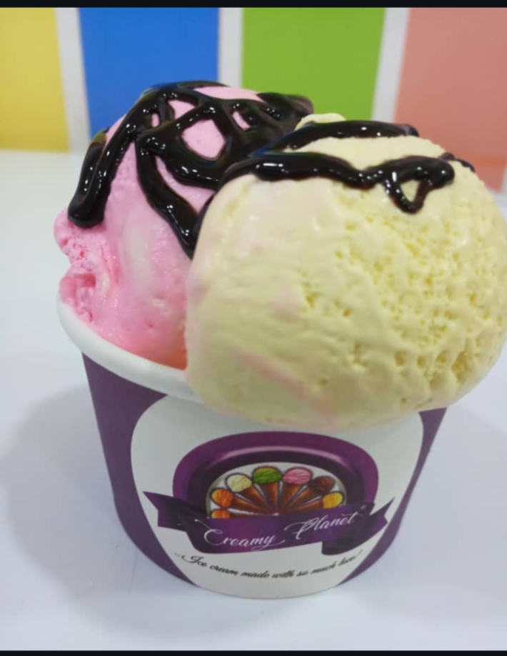 Strawberry and vanilla scoops drizzled with chocolate syrup