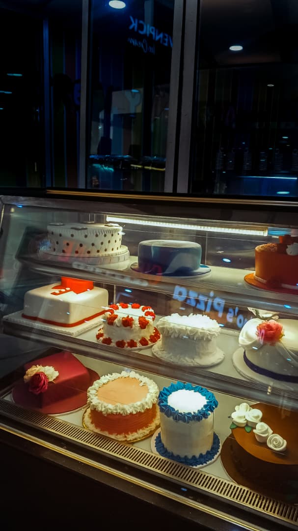 Decorated cakes lit up in the Creamy Planet display case
