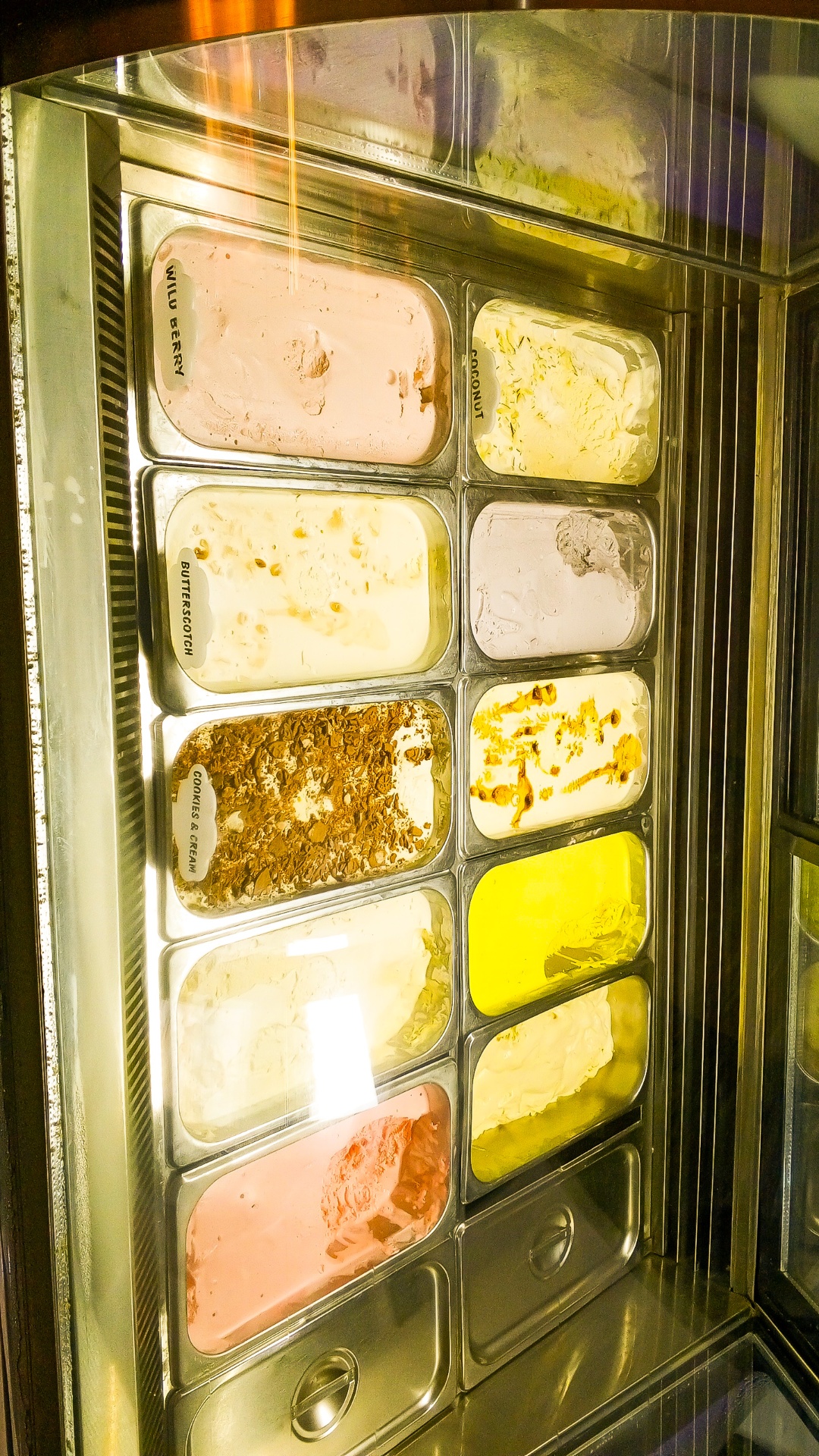 Freezer display of Creamy Planet ice cream flavour tubs